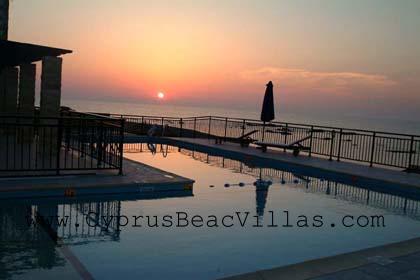 sunset over the swimming pool and the sea